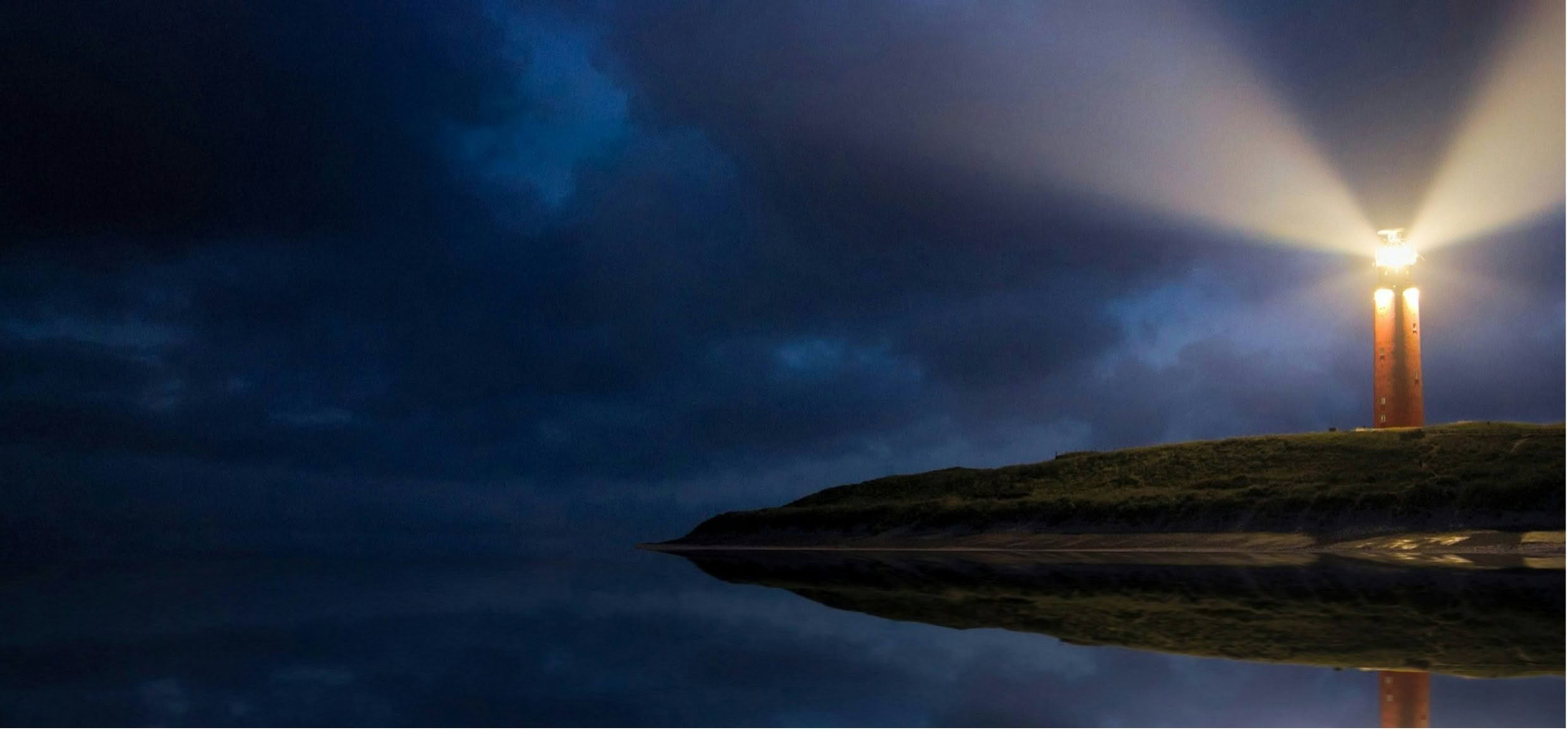 A lighthouse beam cutting through a dark blue night above calm water, representing a decisive 10x moment